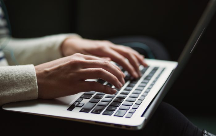 Woman Typing On Laptop